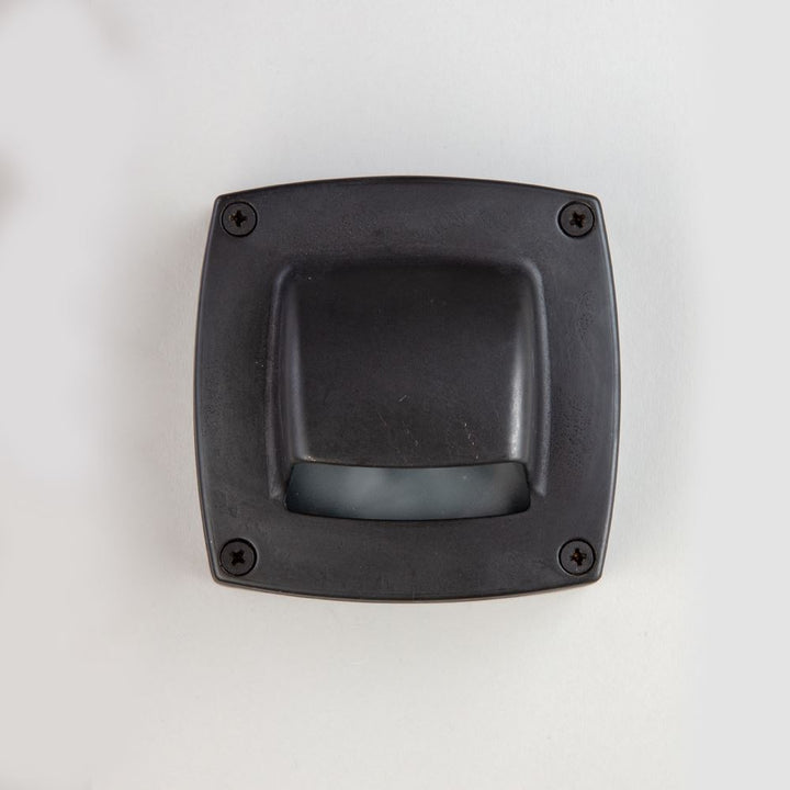 An Old School Electric Square Outdoor Path Light on a white wall.
