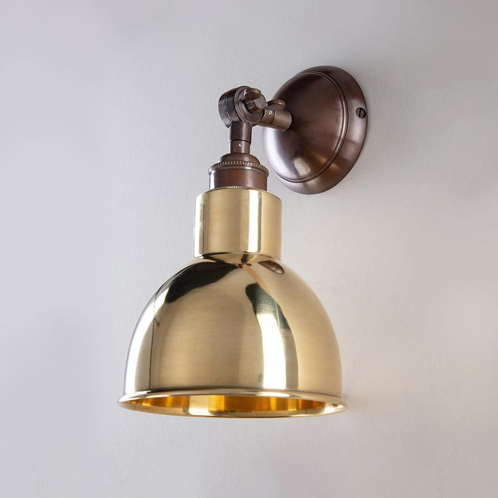 An Old School Electric Churchill Short Arm Wall Light on a white wall.