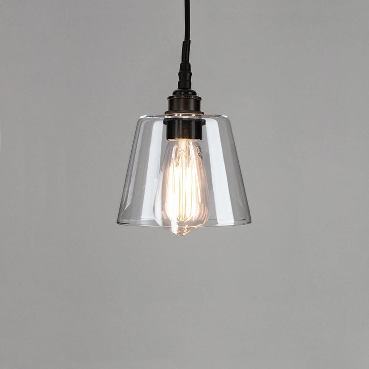 An Old School Electric Tapered Blown Glass Bathroom Pendant Light with a metal frame. Suitable for electric lights and lighting fixtures.