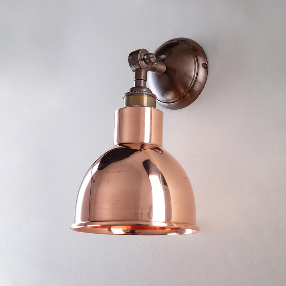 An Old School Electric Churchill Short Arm Wall Light on a white wall.