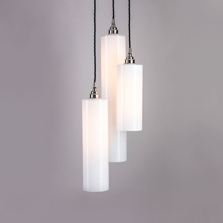 Three Parker Cluster Pendant Lights hanging on a gray background, creating stunning Old School Electric lighting fixtures.