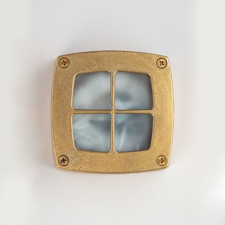 An Old School Electric Square Outdoor Path Light on a white surface featuring a designer light fixture.