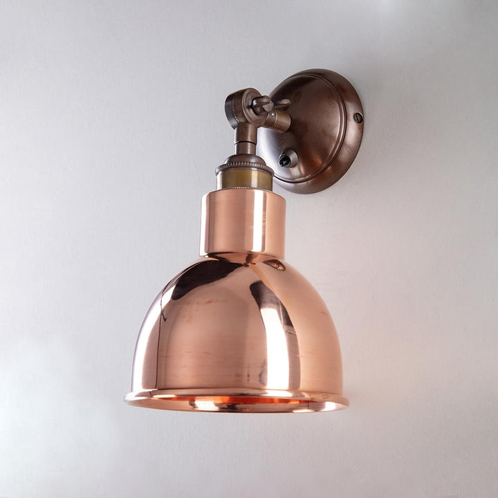 An Old School Electric Churchill Short Arm Wall Light on a white wall.